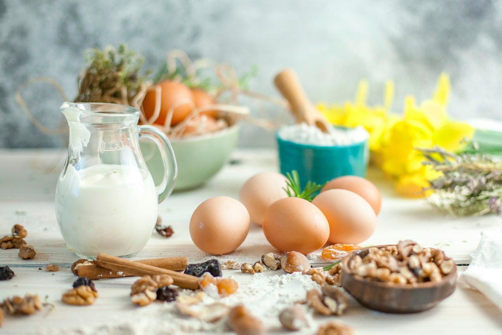 Eggs, nuts, seeds and milk on a table, foods that naturally contain biotin